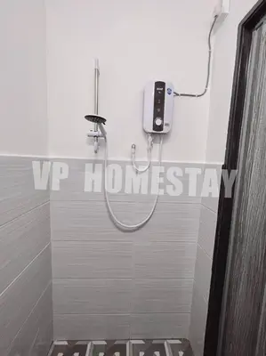a bathroom with a shower with a phone on the wall at VP Homestay - Malay Only in Ipoh