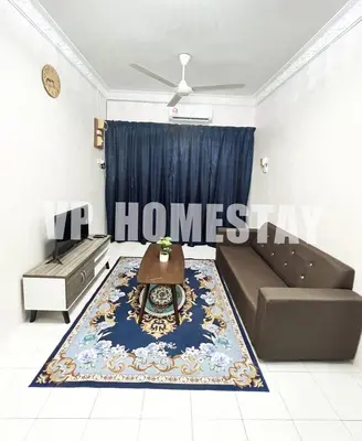 a living room with a couch and a table on a rug at VP Homestay - Malay Only in Ipoh