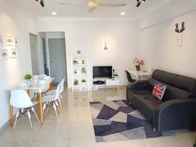 a living room with a black couch and a table at Georgetown, Up to 6 Pax, 3 Bedrooms, 1 Car Park by Star Home in Jelutong
