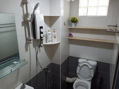 a bathroom with a toilet and a shower in it at Georgetown, Up to 6 Pax, 3 Bedrooms, 1 Car Park by Star Home in Jelutong