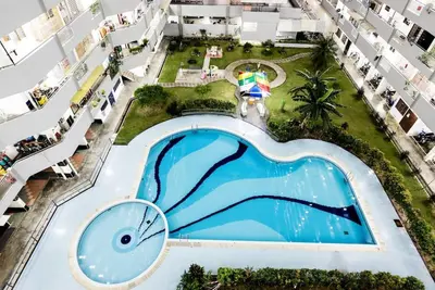 an overhead view of a swimming pool in a apartment building at Georgetown, Up to 6 Pax, 3 Bedrooms, 1 Car Park by Star Home in Jelutong