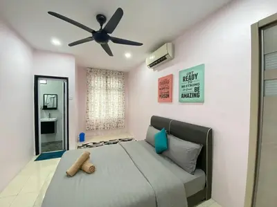 a bedroom with a bed with a ceiling fan at Modern Cozy House 4Room10pax @Near Sunway Carnival in Perai