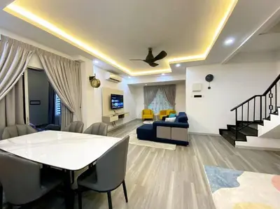 a living room with a table and a couch at Modern Cozy House 4Room10pax @Near Sunway Carnival in Perai