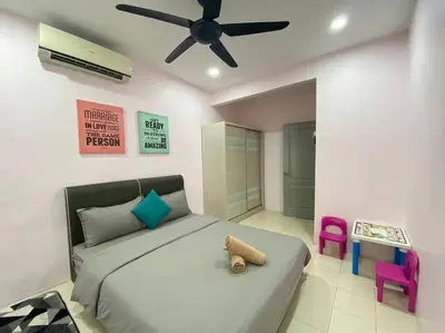 a bedroom with a bed and a ceiling fan at Modern Cozy House 4Room10pax @Near Sunway Carnival in Perai