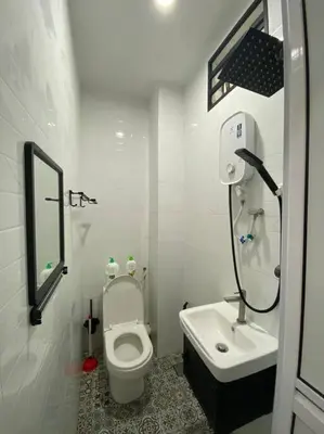 a white bathroom with a toilet and a sink at Modern Cozy House 4Room10pax @Near Sunway Carnival in Perai