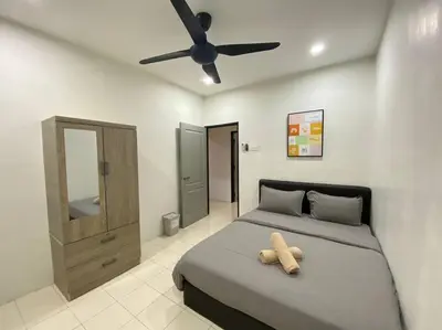 a bedroom with a bed with a teddy bear on it at Modern Cozy House 4Room10pax @Near Sunway Carnival in Perai