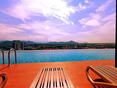 a bench sitting on a deck with a view of a lake at The Horizon Ipoh L8 by Grab A Stay in Ipoh