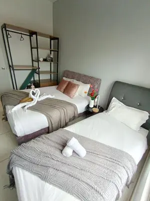 two beds in a hotel room with towels on them at The Horizon Ipoh L8 by Grab A Stay in Ipoh