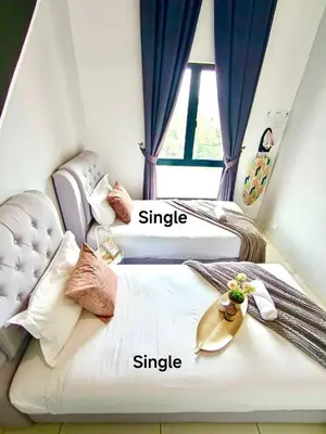 two beds in a room with names of them at The Horizon Ipoh L8 by Grab A Stay in Ipoh