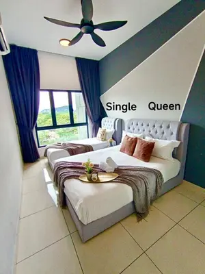 a bedroom with two beds and a ceiling fan at The Horizon Ipoh L8 by Grab A Stay in Ipoh