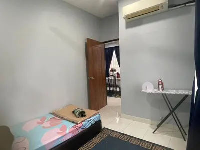 a small room with a bed and a table in it at Homestay Warisan Abang Tam in Kepala Batas