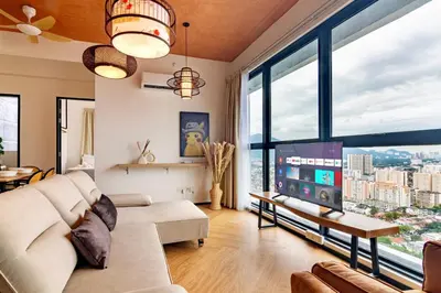 a living room with a couch and a tv at Urban Suites, Classic Collection by Stellar ALV in Jelutong