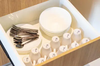a drawer filled with dishes and plates and a stack of dishes at Urban Suites, Classic Collection by Stellar ALV in Jelutong