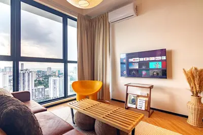 a living room with a couch and a large window at Urban Suites, Classic Collection by Stellar ALV in Jelutong