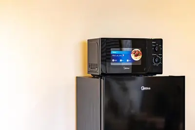 a television sitting on top of a refrigerator at Urban Suites, Spectre Collection by Stellar ALV in Jelutong