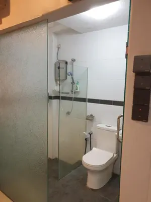 a bathroom with a toilet and a shower stall at Chor Residence Homestay in Ipoh