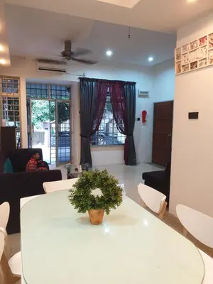 a living room with a white table with a plant on it at Chor Residence Homestay in Ipoh