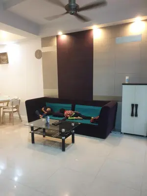 a person laying on a couch in a living room at Chor Residence Homestay in Ipoh