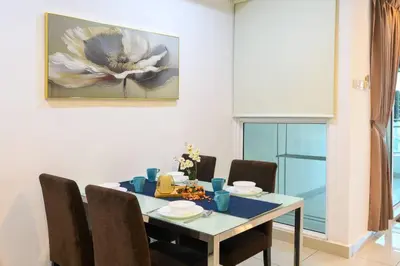 a dining room table with chairs and a painting on the wall at Deluxe Studio/Gurney/Mansion One in George Town