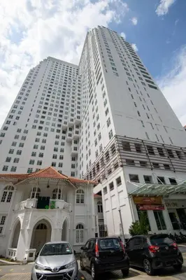 a large white building with cars parked in front of it at Deluxe Studio/Gurney/Mansion One in George Town
