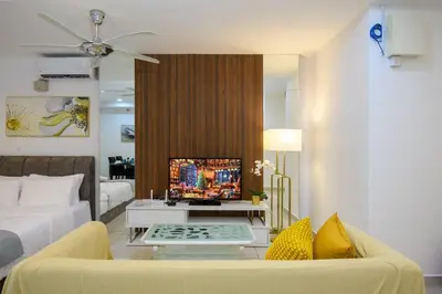 a living room with a couch and a table at Deluxe Studio/Gurney/Mansion One in George Town