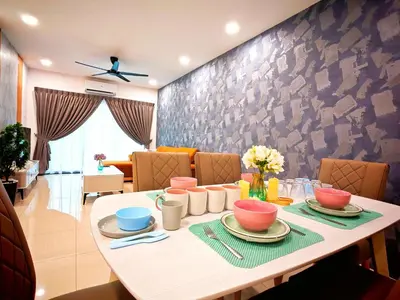 a dining room with a white table and chairs at Ipoh Manhattan Waterpark View 3BR Condo by City Home Empire MHD704 in Ipoh