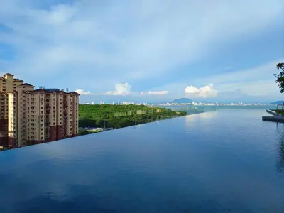 a large body of water with buildings in the background at Urban Suites - George Town, Penang in Jelutong