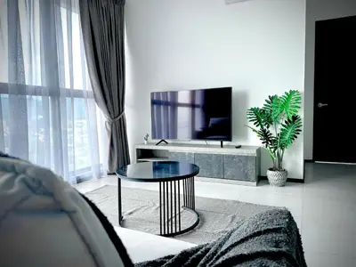a living room with a table and a tv at Urban Suites - George Town, Penang in Jelutong