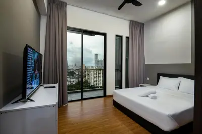 a bedroom with a bed and a large window at Penang KTHOME Beacon Executives suite in George Town