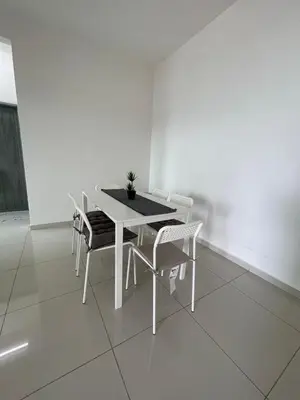 a white table and chairs in a white room at Rumah Puteh Homestay in Ipoh