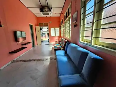 a blue couch in a room with orange walls at Wi-Fi 100MB Free Ipoh Happy Big House SemiD TH24 16 pax in Ipoh