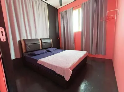 a bedroom with a bed in a red room at Wi-Fi 100MB Free Ipoh Happy Big House SemiD TH24 16 pax in Ipoh