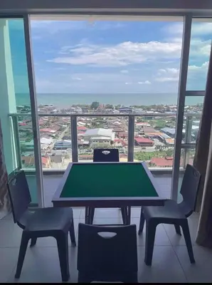a table and chairs in a room with a view of the ocean at Sekinchan Simple LoveSea House ~ Seaview 3-14AB in Sekincan