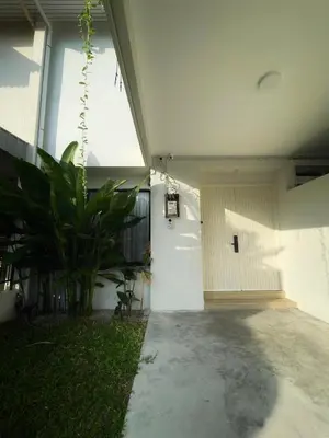 a white door in a building with a plant at Designer Guesthouse Pulau Tikus & Gurney Drive, Georgetown, Penang in George Town