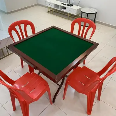 a table with two red chairs and a green top at Sekinchan Simple Love SeaHouse - PaddyView 8-7A in Sekincan