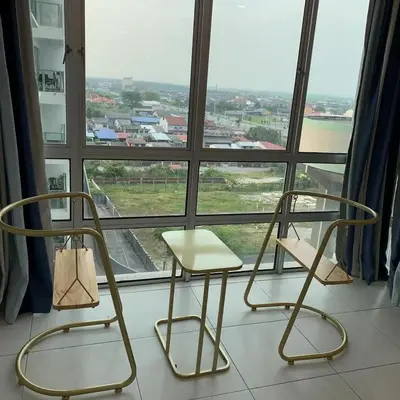 two chairs and a table in front of a window at Sekinchan Simple Love SeaHouse - PaddyView 8-7A in Sekincan