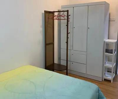 a bedroom with a bed and a dresser at Sekinchan Simple Love SeaHouse - PaddyView 8-7A in Sekincan