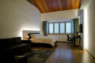 a large bedroom with a bed and a couch at Quint Residence, Georgetown - Rustic Heritage Guesthouse by ALV in George Town