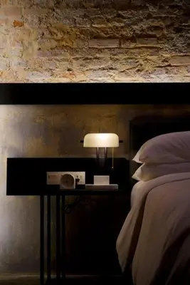 a bedroom with a bed and a table with a lamp at Quint Residence, Georgetown - Rustic Heritage Guesthouse by ALV in George Town