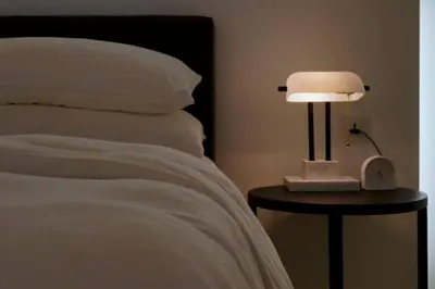 a bed with a lamp on a table next to it at Quint Residence, Georgetown - Rustic Heritage Guesthouse by ALV in George Town