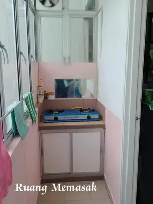 a bathroom with a shelf with a blue item on it at Hakimi Homestay in Tanah Rata
