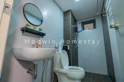 a bathroom with a toilet and a sink and a mirror at Comfy Studio Room by Moowin in Perai