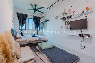 a living room with two beds and a flat screen tv at Comfy Studio Room by Moowin in Perai