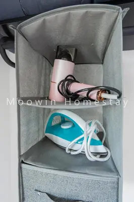 a box with a bottle and a mouse and shoes at Comfy Suite by Moowin in Perai