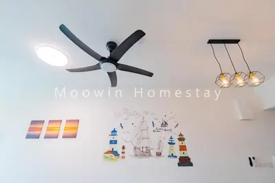 a ceiling fan in a room with a wall at Comfy Suite by Moowin in Perai