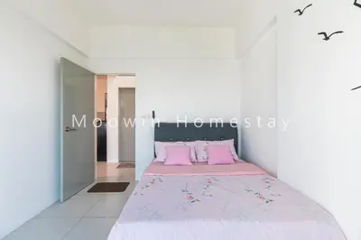 a white room with a bed with pink pillows at Comfy Suite by Moowin in Perai