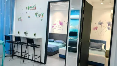 a mirror in a room with a bed and a bedroom at Ocean Home@Urban Suites@12 Pax in Jelutong