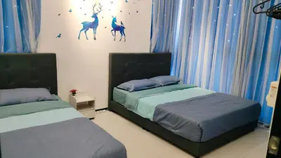 two beds in a bedroom with blue curtains at Ocean Home@Urban Suites@12 Pax in Jelutong