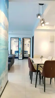 a dining room with a table and chairs at Ocean Home@Urban Suites@12 Pax in Jelutong