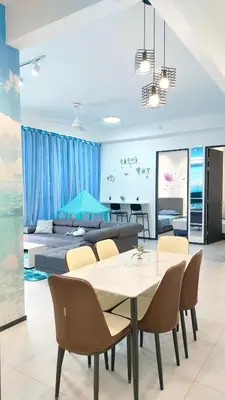 a dining room with a table and chairs and a couch at Ocean Home@Urban Suites@12 Pax in Jelutong